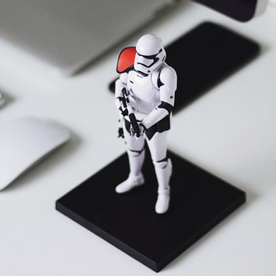 A starwars storm trooper toy standing guard over a computer